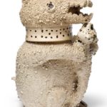 A RARE STAFFORDSHIRE WHITE SALT-GLAZED STONEWARE BEAR PUZZLE JUG AND COVER CIRCA 1745-50